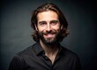 © Achiraya - A Man With Mid-Length Hair And A Full Beard Poses With A Subtle Smile, Wearing A Plain, Dark-Colored Shirt.