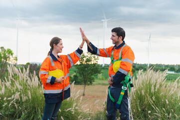 Wall Mural - two people in orange safety vests shake hands