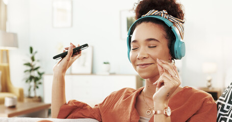 Poster - Happy woman, headphones and dancing with phone for music, listening or podcast on sofa at home. Young, female person or dancer enjoying audio streaming, sound or tune with headset or smile at house