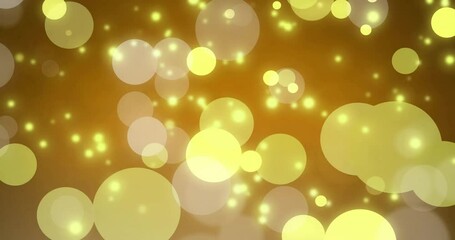 Sticker - Glowing yellow bokeh lights animation over golden background