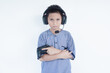 © AriaSandi - Young Asian kid playing video game holding controller wearing headphones depressed and worry for distress, crying angry and afraid. sad expression.