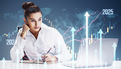 Canvas Print - Businesswoman working at desk with upward growth charts and graphs overlay on digital background.