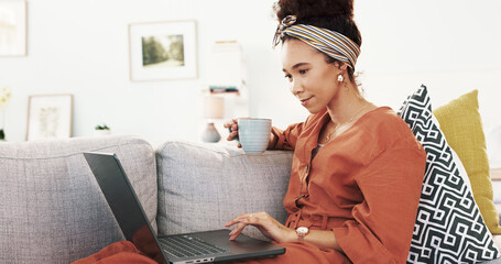 Wall Mural - Happy woman, coffee and relax with laptop on sofa for online browsing, research or app at home. Young, female person or vlogger with caffeine or computer on couch for reading or scrolling at house