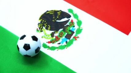 Wall Mural - Soccer ball on Mexican flag spinning on table