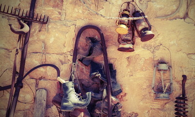 Antique Utensils on the Wall on a sunny day outside. Beautiful vintage background. Garden Decorative Decision