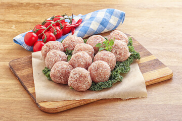 Wall Mural - Raw pork meatball over board