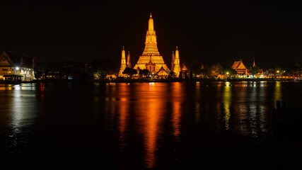 beautiful wat arun ratchawararam temple with reflexion in the river at twilight in bangkok thailand