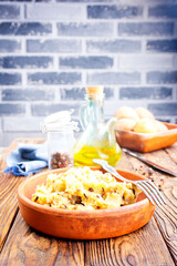 Canvas Print - Simple food mashed potatoes with caramelized onions close-up on a plate on the table.