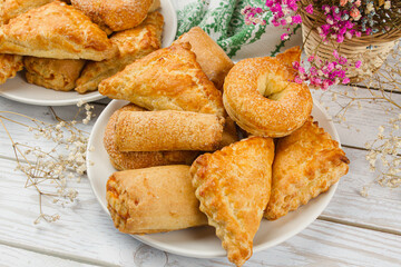 Wall Mural - Plate with homemade pastries on a light table. Sweet breakfast