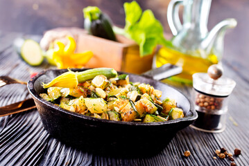 Canvas Print - Baked vegetables in pan on a table, close up view