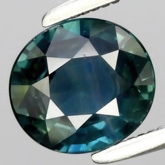 Wall Mural - Exquisite Multicolored Faceted Sapphire Gemstone with Elegant Deep Blue and Green Tones