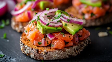 Wall Mural - Salmon tartare with avocado, onion, on rye bread.