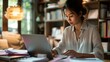 © AlfaSmart - Focused Woman Working on Laptop at Home Office