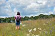 © Oleksandr Filatov - Woman. girl in nature. walk in summer, sunny day. spring season. back view. outdoor walk, tourism. walking through a field of flowers. walking with a backpack along a field path