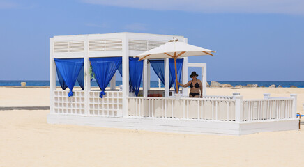 Wall Mural - seaside resort beach with white sand and a gazebo for relaxation