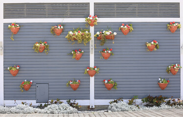 Wall Mural - bouquet of artificial flowers in a basket on the wall