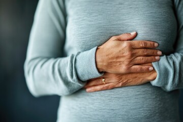 Woman with abdominal pain putting her hands on her stomach, healthcare medical concept