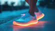 © ЮРИЙ ПОЗДНИКОВ - Woman wearing light up led sneakers walking in the city at night