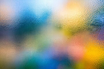 Wall Mural - colorful abstract blurry background with textured glass effect and vibrant hues of blue and yellow