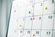 © Who is Danny - Closeup of a calendar with colorful pins marking important dates. 3D Rendering