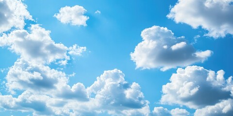 Wall Mural - Bright blue sky with fluffy white clouds as the background.