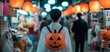 © Wan - Person with a pumpkin backpack walks through a lantern-lit market, creating a festive and spooky Halloween atmosphere.
