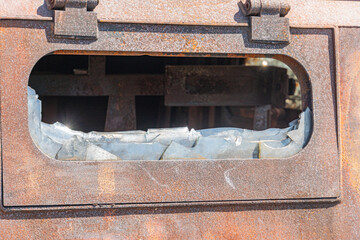 A detailed view of the interior of a war-torn car, with rust and decay taking over every surface. damaged military tank on the city street war in Ukraine with Russia. detail texture