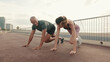 Multiethnic sportsman and sportswoman doing mountain climber exercise, sporty bodybuilders doing running dynamic plank, loss weight cardio street workout