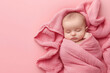 © Ignats - Cute newborn baby wrapped in a pink blanket on a pink background