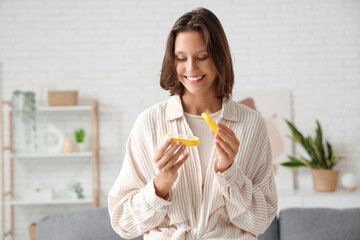 Poster - Pretty young woman with pill organizer at home