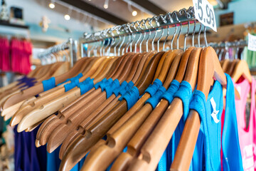 Close-up of blue t-shirts hanging on cloth hanger