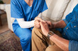© Chanelle2000/peopleimages.com - Holding hands, nurse and closeup in home for support, empathy and palliative care for healthcare. Comfort, medical caregiver and person with kindness, trust and help patient with cancer for healing