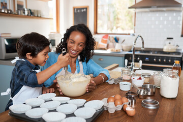 Wall Mural - Baking, smile and mother with child in kitchen for bonding, food and learning. Cooking, love and cupcake with people and ingredients in family home for breakfast, teaching and happiness together