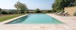 © Cheewynn - Empty swimming pool with crystal-clear water, positioned in a quiet, scenic countryside setting, offering a private escape, private escape, countryside luxury