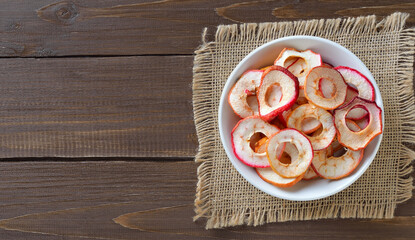 Wall Mural -  Dried apple rings in white bowl.