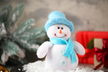 Wall Mural - Funny snowman figure in hat on table, closeup