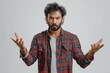 © Road Red Runner - An aggressive Indian man with a displeased expression gestures emphatically during a conversation in a neutral setting