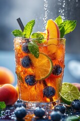 Wall Mural - A glass of mixed fruit juice with blueberries and limes. The juice is cold and refreshing, and the fruit garnish adds a pop of color and flavor