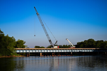 crane on bridge over the river