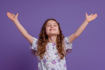 Wall Mural - A young girl with her hands raised in excitement or anticipation, possibly during a performance or celebration