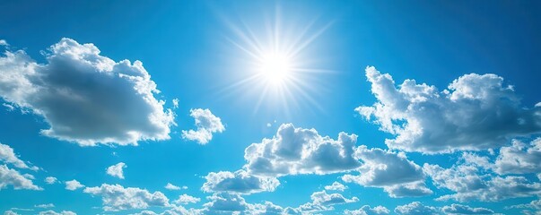 Clear blue sky with a few white clouds, serene weather, bright sunlight