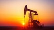 © tashechka - An oil pumpjack is silhouetted against the colorful hues of a sunset in a serene desert setting