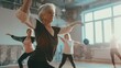 © paisorn - Aged women performing modern dance during their group training in fitness room