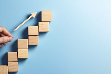 Hand Moving Wooden Blocks with Arrow Direction on Soft Blue Background