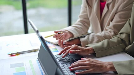 Wall Mural - Teamwork process Two businesswomen are discussing income analysis. Analyze charts Growth in financial business online marketing Calculating income, operating results, business planning.