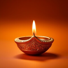 Indian festival happy Diwali oil lamp or diya on orange background