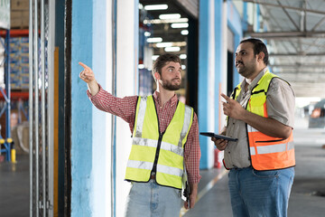 Wall Mural - Warehouse concept. Two male warehouse worker working and checking, receive of products in warehouse