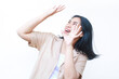 © M Alfan Setyawan - surprised asian woman raising hand over her head and looking up wearing casual brown clothes isolated on white background