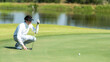 © freebird7977 - Golfer sport course golf ball fairway.  People lifestyle man  putting golf ball on the green grass.  Asian man player game shot in summer.  Healthy and Sport outdoor