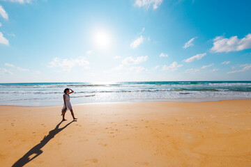 Wall Mural - girl on the beach. a girl in stylish summer clothes walks along the beach. gorgeous sexy woman with a perfect slim body outdoors.